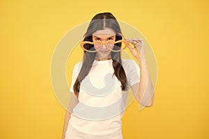 Surprised woman, shocking girl wearing funny glasses on isolated yellow background, Wow face feelings with copy space