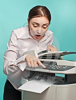 Surprised woman with smoking copier