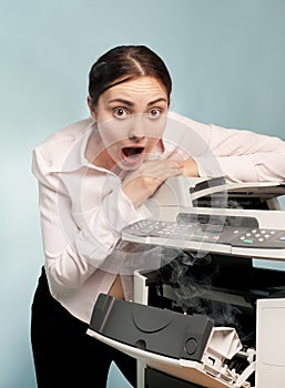 Surprised woman with smoking copier