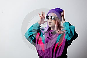 Surprised woman in sunglasses and 80s sportsuit