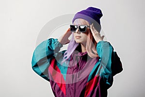 Surprised woman in sunglasses and 80s sportsuit