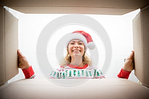 Surprised woman unpack Christmas gift box