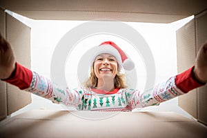 Surprised woman unpack Christmas gift box