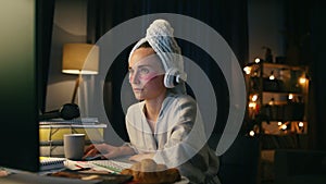 Surprised woman watching screen closeup. Domestic girl in headphones working