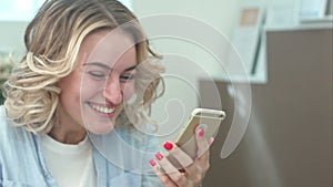 Surprised woman watching screen of mobile phone