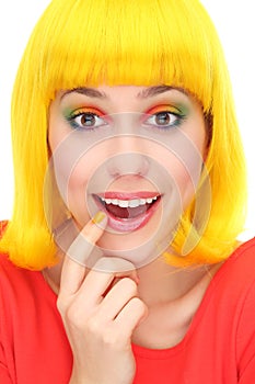 Surprised woman wearing yellow wig