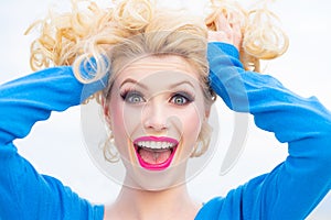 Surprised woman. Woman face with hair motion on white background isolated close up portrait.