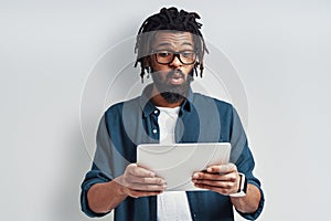 Surprised young African man in eyewear