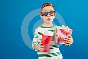 Surprised young boy in eyeglasses preparing to watch the film