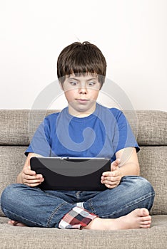 Surprised young boy and a tablet digital
