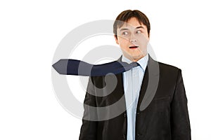 Surprised young businessman with blowing necktie