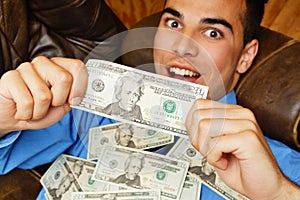 Surprised young businessman with money