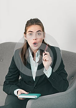 Surprised young businesswoman working on laptop with too much work in office. Secretary girl.