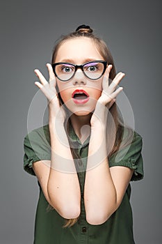 Surprised young girl with glasses