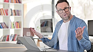 Surprised Young Man in Glasses Looking at Camera at Work