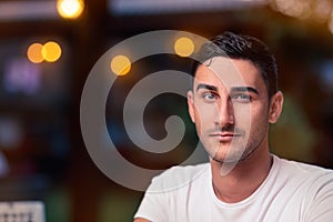 Surprised Young Man Sitting in a Restaurant