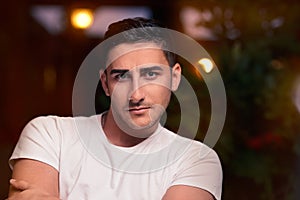 Surprised Young Man Sitting in a Restaurant