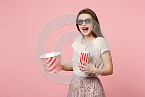 Surprised young woman in 3d imax glasses posing isolated on pastel pink background. People sincere emotions in cinema