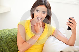 Surprised young woman covering her mouth
