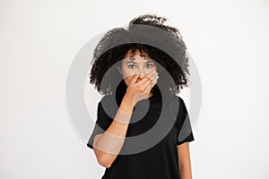 Surprised young woman covering her mouth with hand