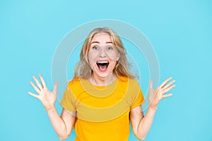 Surprised young woman feeling excited and expressing emotion of joy