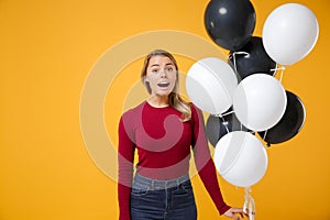 Surprised young woman girl in casual clothes posing isolated on yellow orange background. Birthday holiday party, people