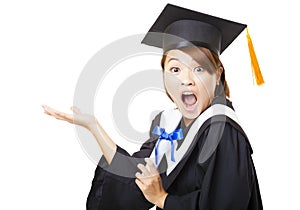 Surprised young woman graduating holding diploma