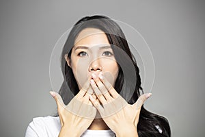Surprised young woman hands coverd the mouth