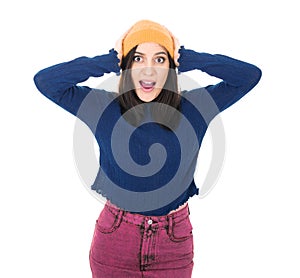 Surprised young woman with hands on his head, isolated on white background. Positive news. Astonished pretty girl