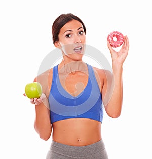 Surprised young woman holding food temptations photo