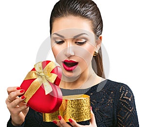 Surprised young woman opening heart shaped gift box