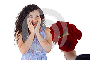 Surprised young woman receive bouquet of red roses.