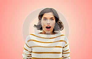 Surprised young woman in striped pullover