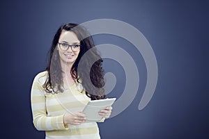 Surprised young woman using holding a digital tablet