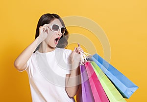 Surprised young woman watching the shopping bags