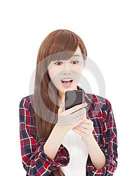 Surprised young woman watching the smart phone
