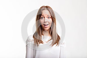 Surprised young woman with wide eyes