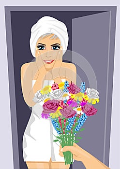 Surprised young woman wrapped in white towel