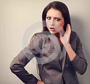 Surprising angry business woman with hand near face. Toned close