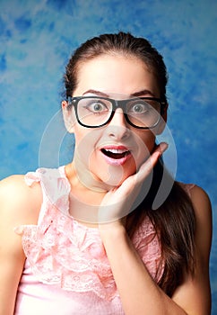 Surprising woman in glasses with opened