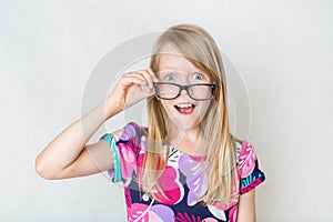 Surptised girl in black glasses