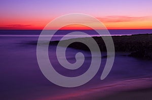 Surreal deserted sandy beach after dusk