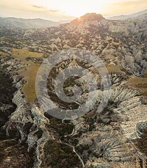 Surreal dramatic deserted earth landscape panorama with beautiful cliff formations and golden sunset background in Vashlovani