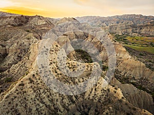 Surreal dramatic deserted earth landscape panorama with beautiful cliff formations and golden sunset background in Vashlovani