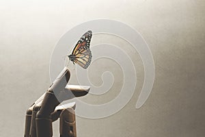 Surreal encounter between a wooden hand and a colorful butterfly