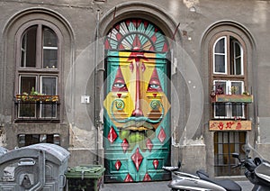 Surreal face painted on a door in 12 Kazincy Street, Budapest, Hungary