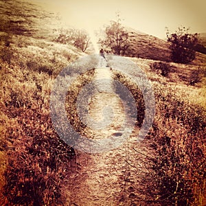 Surreal grungy landscape mountain hill with track and sky