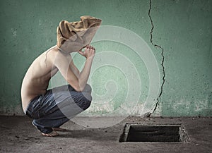 Surreal image with bag over his head shirtless and blue jeans