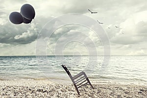 Surreal image of a chair held in balance by flying balloons photo
