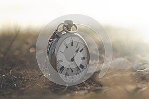 Surreal image of a clock in a mystical and mysterious landscape